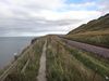 The path sandwiched between the raiway line and cliff edge.