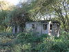 Old huts by the railway trackbed.