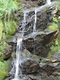 A waterfall beside the track.