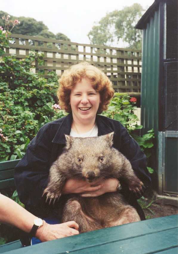 Sam holding a wombat at the wildlife reserve 