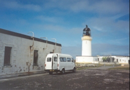 AX09	The lighthouse with the minibus in front of it.