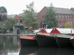 PB110142	A man tying up a working boat in Gas Street Basin.