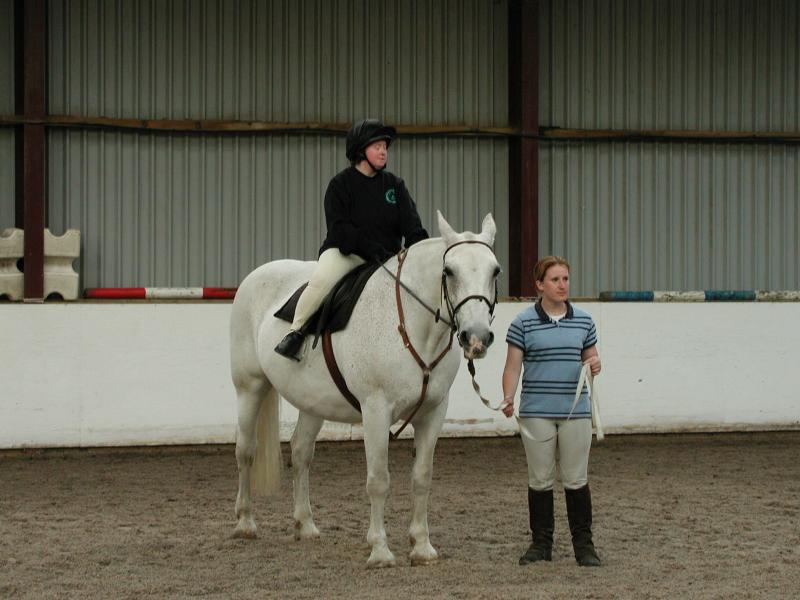 A disabled lady riding a horse.