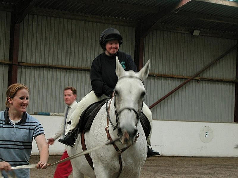 A disabled lady riding a horse.