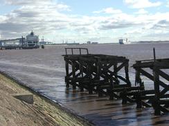 P2002A230014	The woodwork of a decaying pier on the riverfront. 