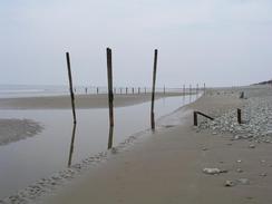 P20033280703	Old rails sticking out of the beach to the north of Tywyn.