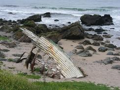 P20036244533	The remains of a boat on a beach.