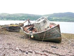 P20037316191	A ruined boat on  the foreshore of Loch Broom.