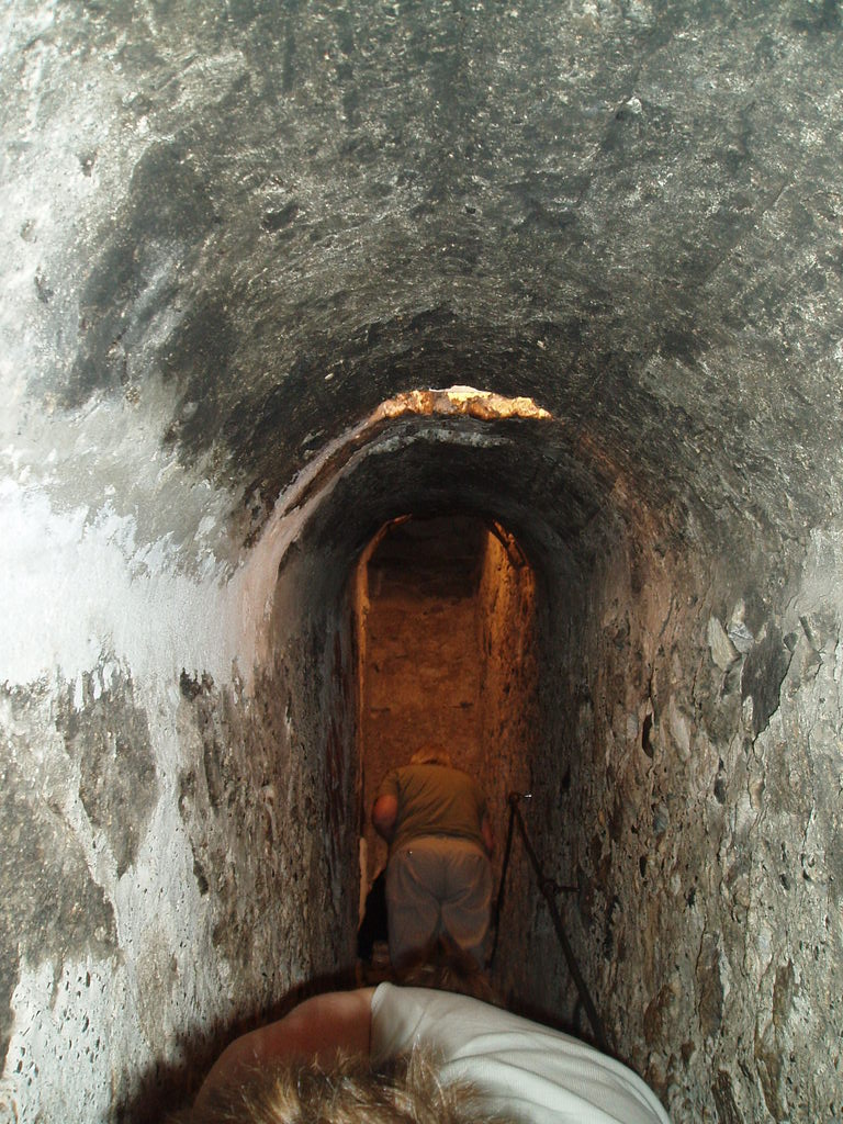 Climbing up a narrow staircase into Bran Castle.