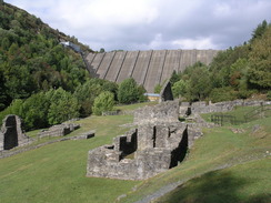 P20069234453	The ruins of Bryntail Mine, with the Clywedog Dam behind.