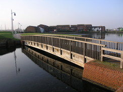 P2007C192063	The footbridge over the entrance to a marina.