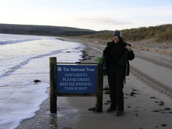 P20081122262	Sencan by the nudist sign on Studland Beach.