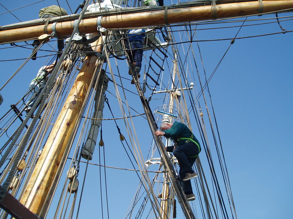 Doing the 'up and over' on the main mast.