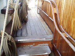 P20089215400	The curved handrail leading towards the stern of the ship.