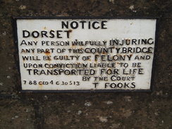 P2010A300336	A sign on a bridge in Charmouth.