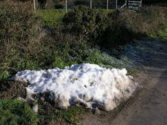 P2010C091045	A pile of snow beside the road.