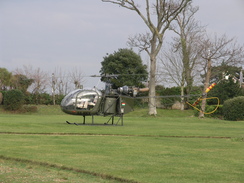 P20111272414	A helicopter in the grounds of a house.