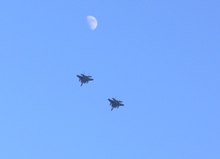 P201120113143277	Two jet fighters and the moon.