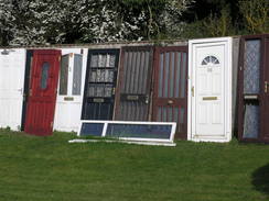 P20113243683	Doors lined up outside a salvage yard.