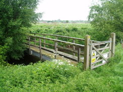 P20115160075	A footbridge over a stream leading to the River Whitham.