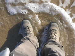 P20115256404	Washing my boots in the sea.