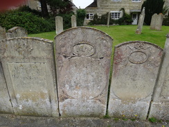P2011DSC01214	Gravestones on the boundary of Ketton churchyard.