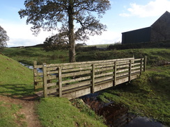 P2011DSC05349	A footbridge over a stream at Green Croft.