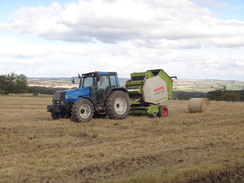 P2011DSC05682	A bailer working in a field.