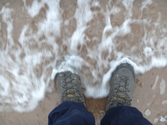 P2011DSC07274	Washing my boots in the sea.