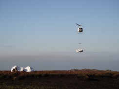 P2011DSC07950	A helicopter dropping off bags of chopped heather.