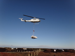 P2011DSC07964	A helicopter carrying bags of chopped heather.