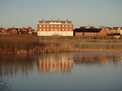 P2012DSC08485	The faux-Georgian house in Cambourne viewed over Whomping Willow lake.