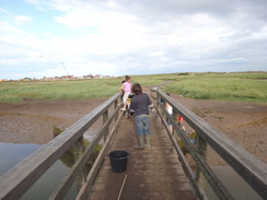 P2012DSC01889	People crabbing off a footbridge in Walberswick.