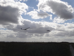 P2012DSC02609	A plane towing a glider into the sky.