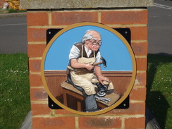P2018DSC09885	A cobbler on Cogenhoe village sign.