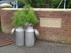 P2018DSC01910	Flowering milk churns outside Tilley Farm.