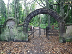 P2019DSCF3739	An archway leading out of Priory Woods.