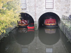 P2019DSCF3777	Narrowboats moored under a building at Wigan Pier.