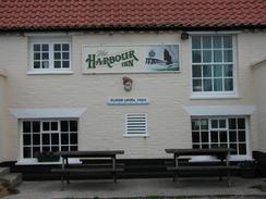 P2002B080067	The Harbour Inn, with a marker on it showing the height of the 1953 floods. 