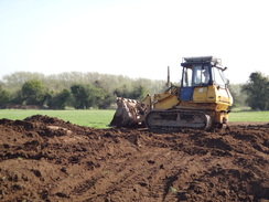 P2012DSC09670	A bulldozer filling in a hole.